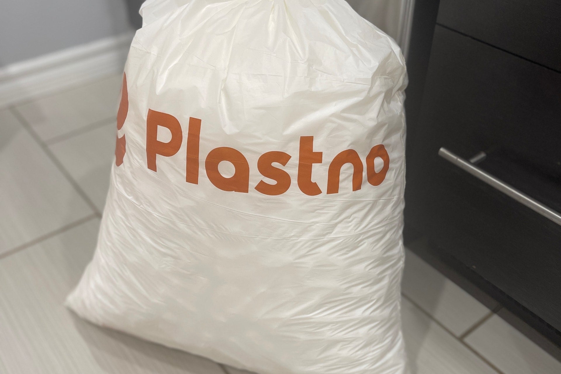 Plastno compostable trash bags full of trash, spotting greenwashing in compostable trash bag claims
