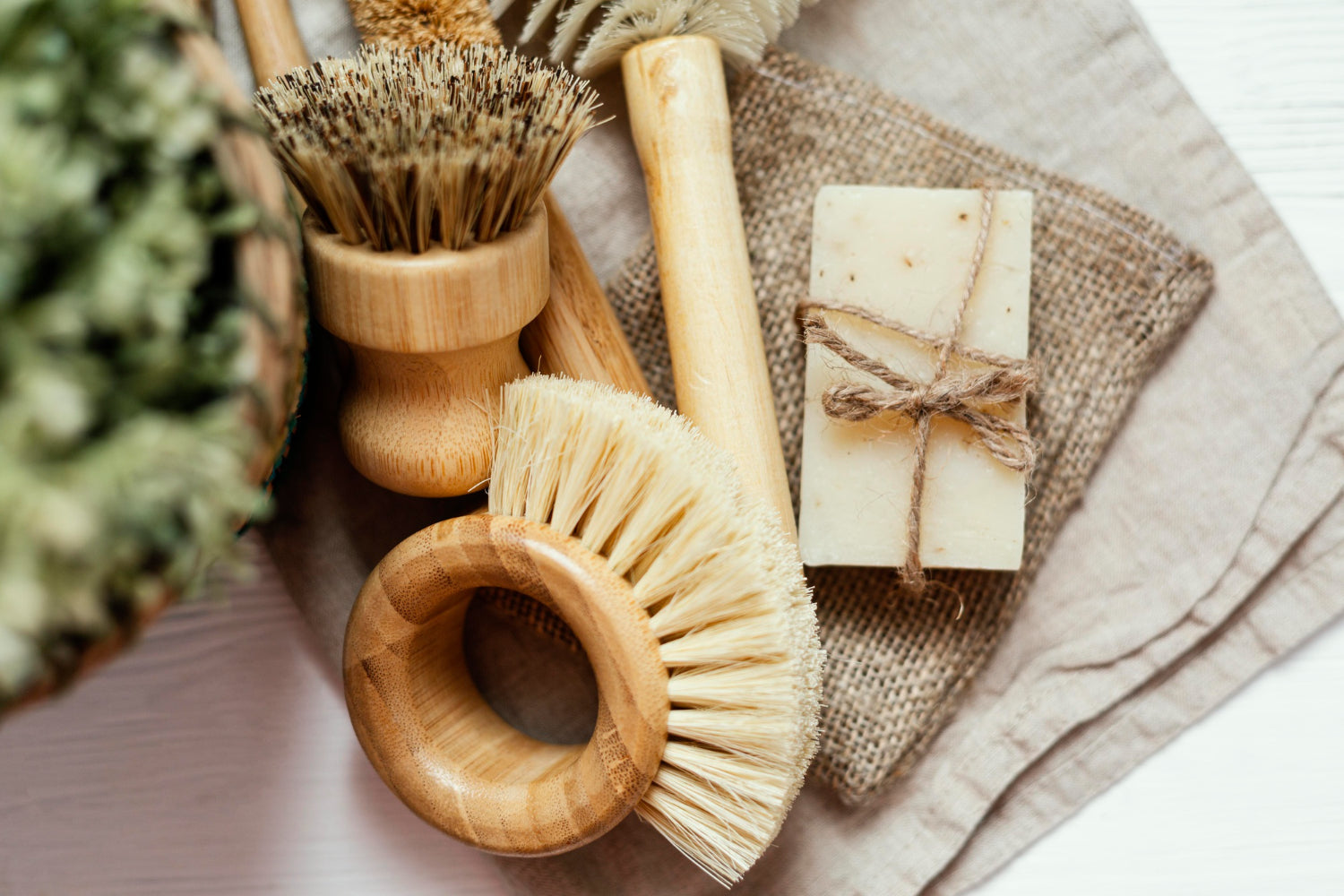 Sustainable cleaning tools laid out for a room-by-room guide to ditching plastic cleaning tools