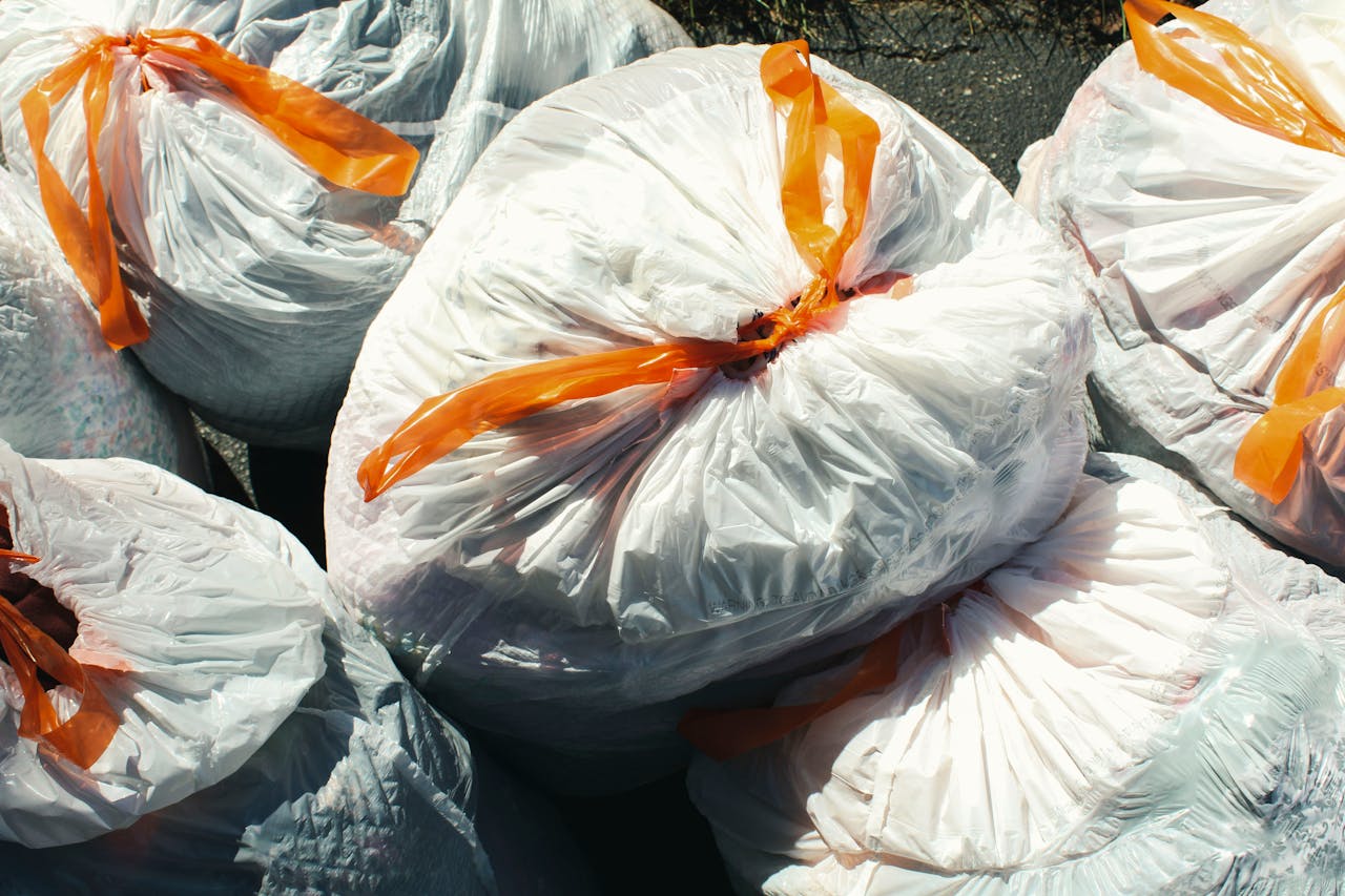 Filled garbage bag at the curb, why biodegradable garbage bags matter for the environment
