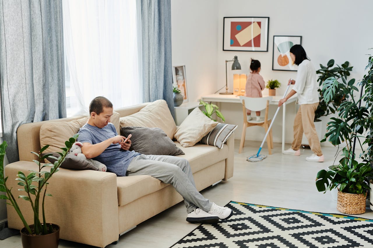 Parent tidying up at home, a simple cleaning routine and schedule for busy parents