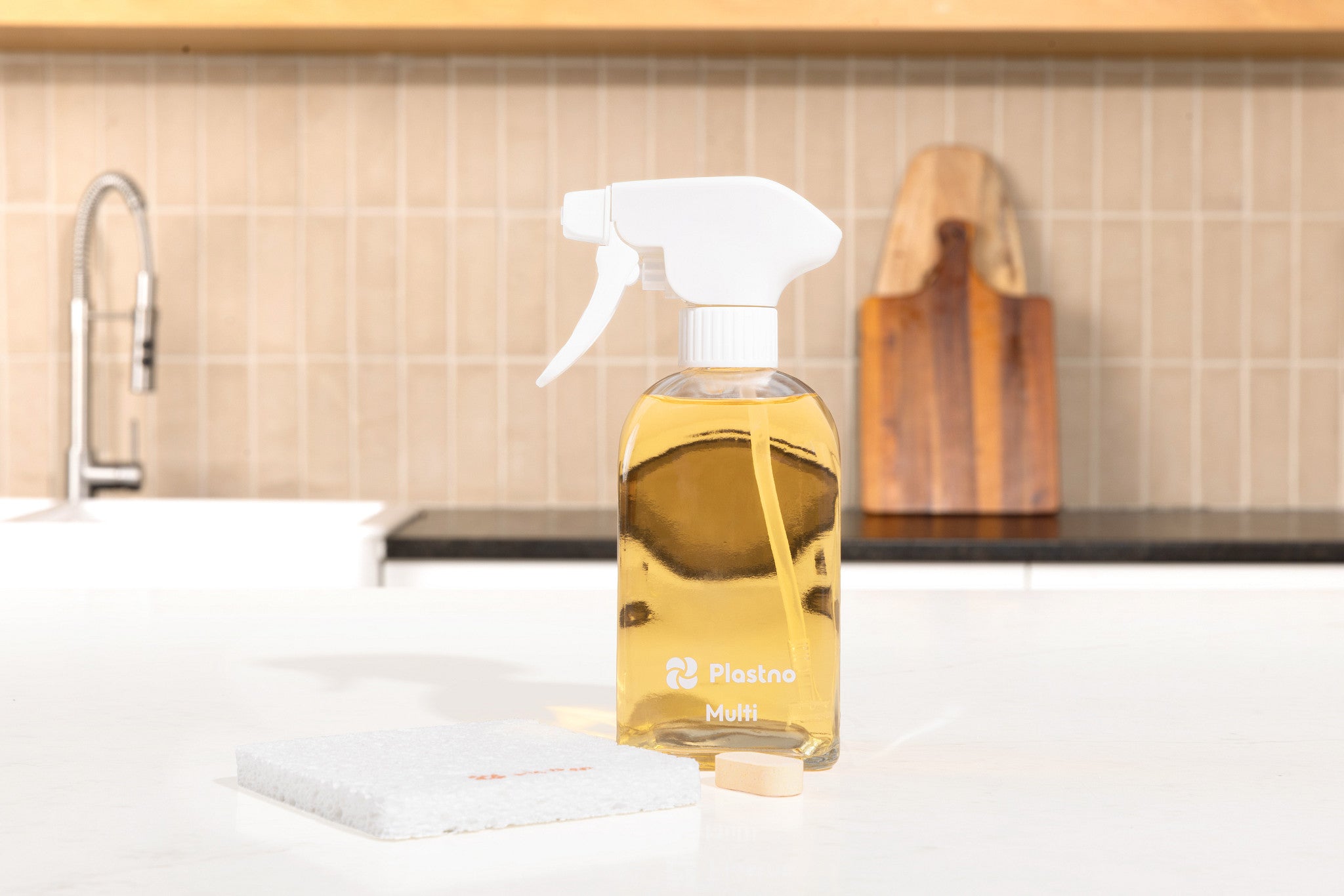 Plastno refillable glass multi cleaner spray bottle on a kitchen counter