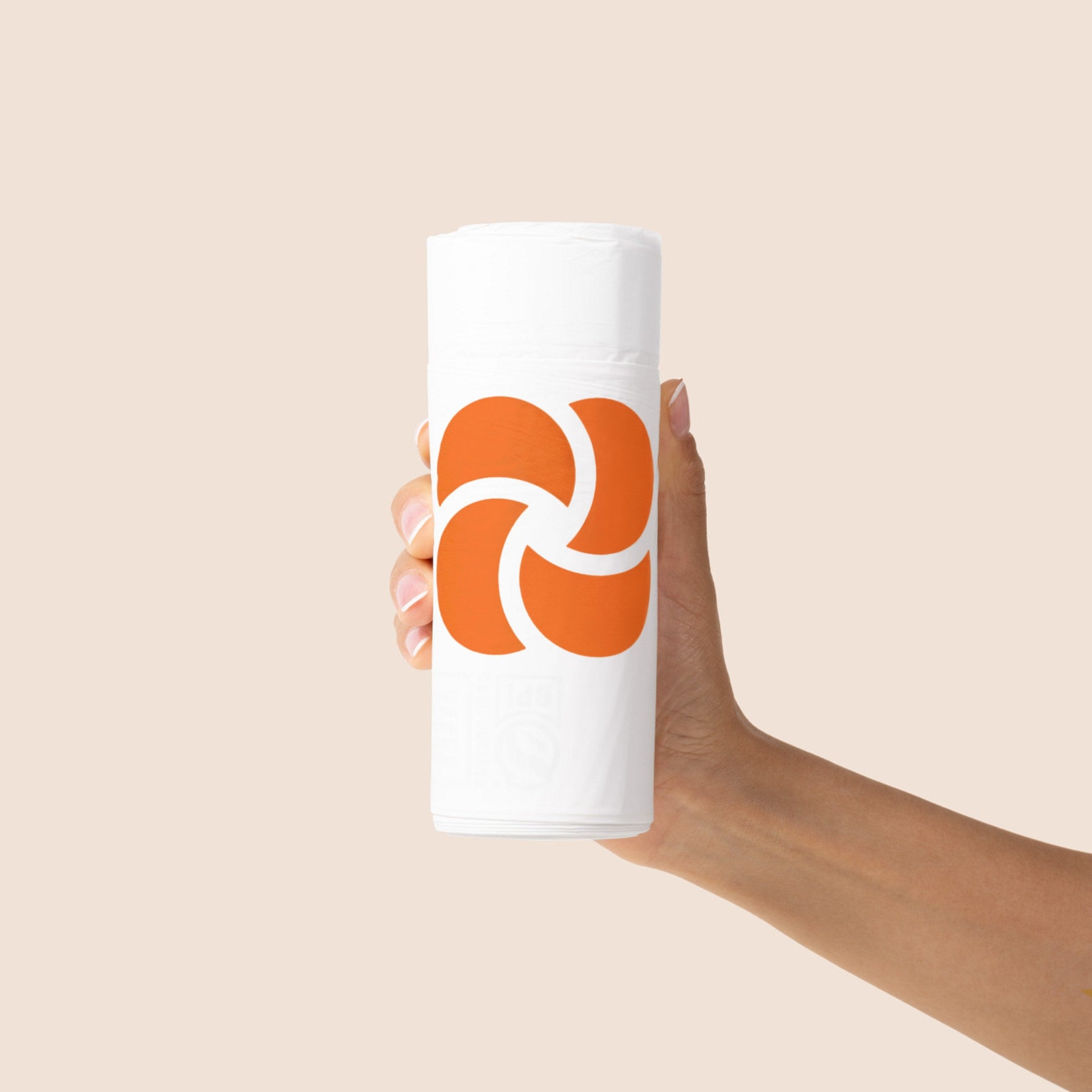 Hand holding a roll of 30 Plastno 4 gallon compostable trash bags