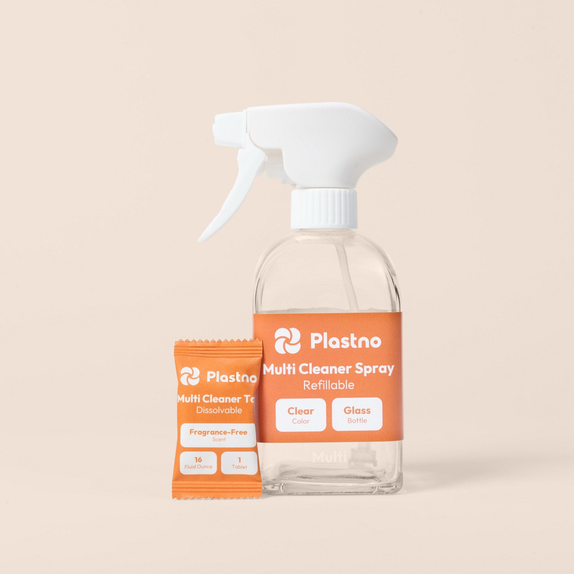 Plastno refillable Multi Cleaner Spray glass bottle next to a fragrance-free multi cleaner tablet packet on a beige background