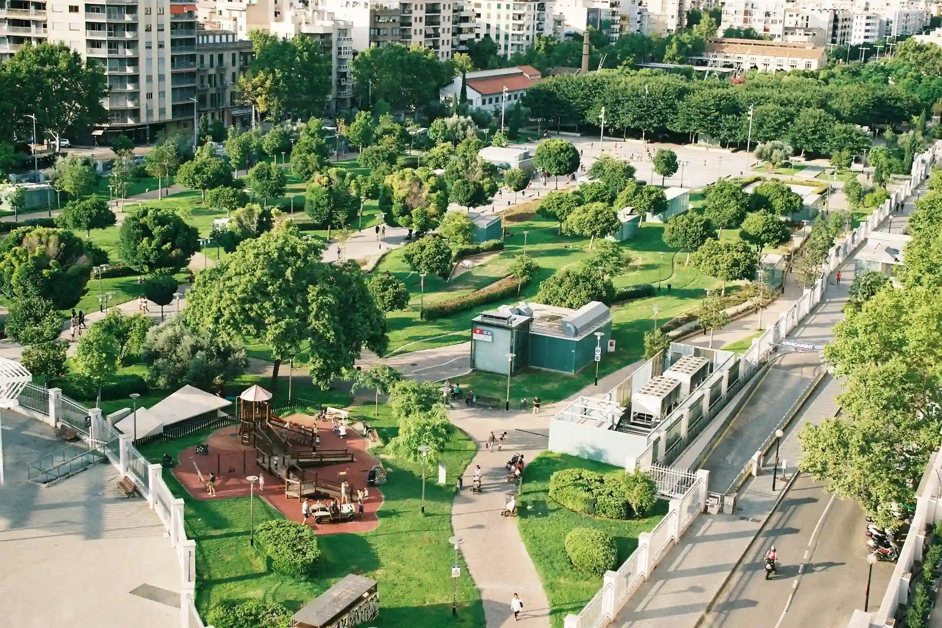 Aerial view of a park with greenery and pathways in an urban setting