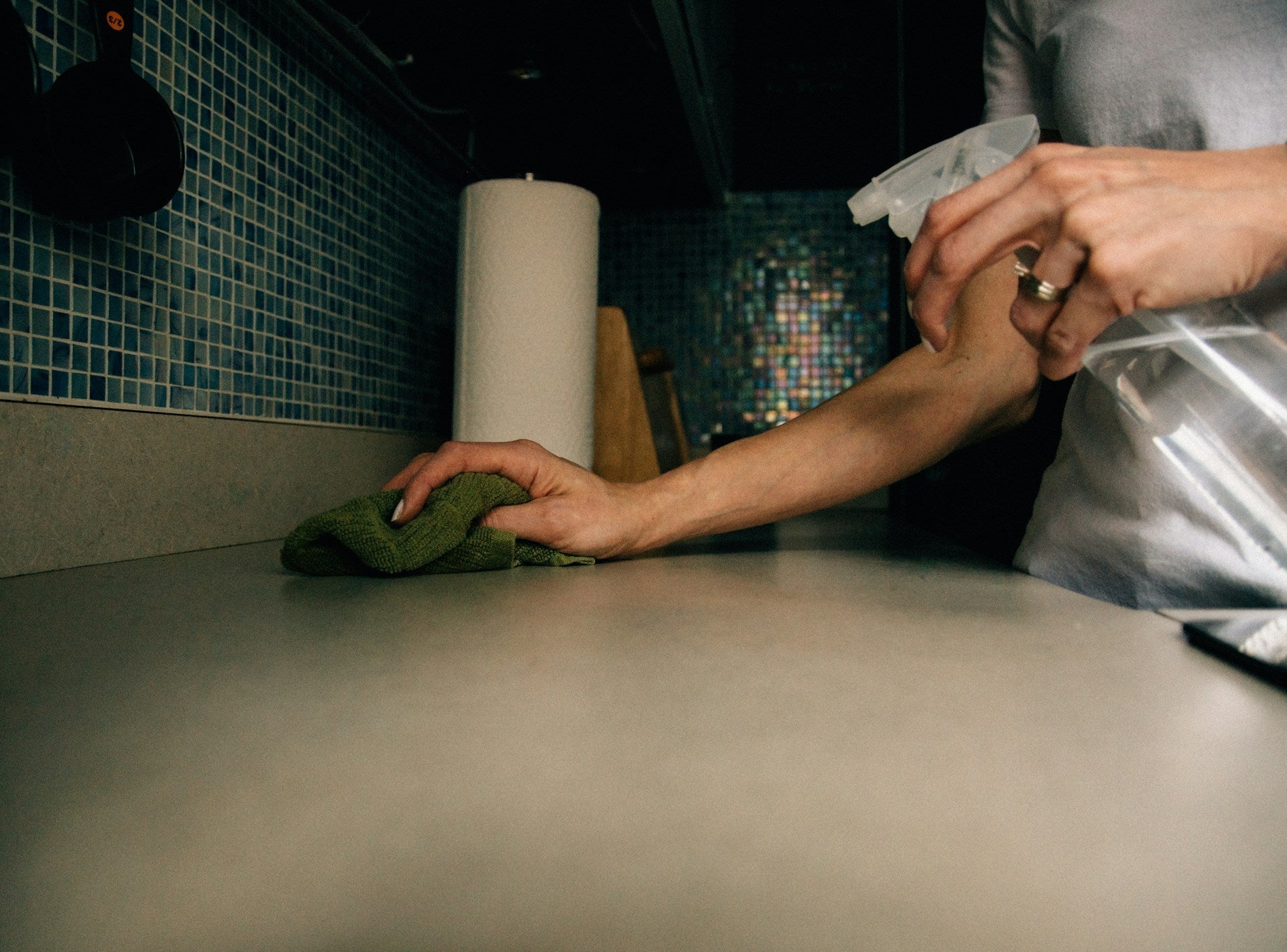 A jumble of harsh conventional cleaners and bleach crowded under a sink, the kind a non-toxic, kid- and pet-friendly routine replaces
