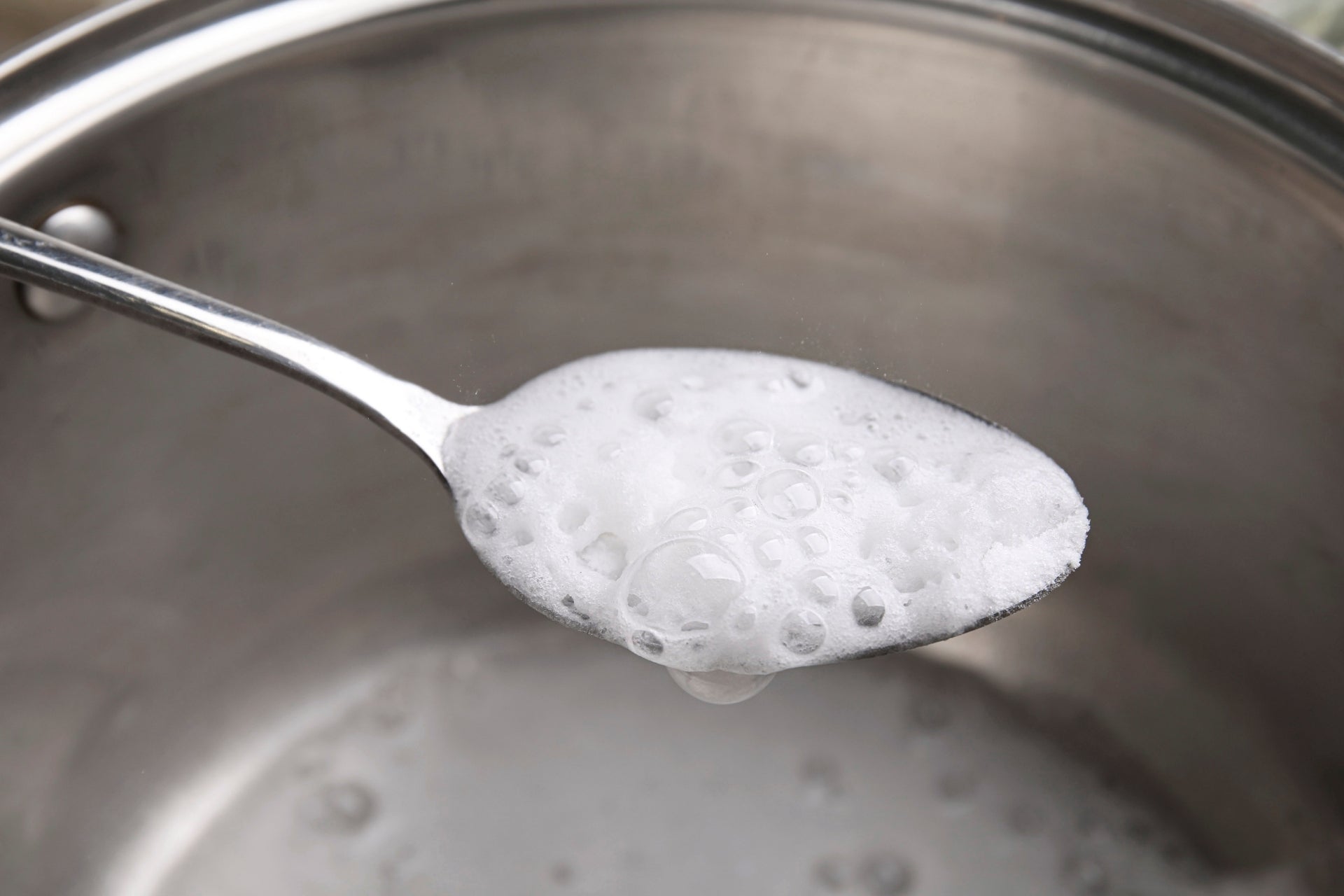 Three bowls of white cleaning powder side by side: baking soda, washing soda and borax