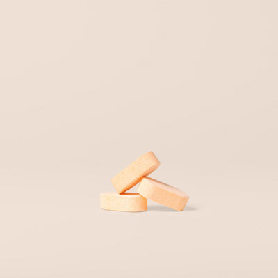 Three Plastno dissolvable multi cleaner tablets stacked on a beige background