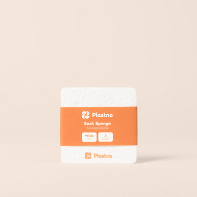Plastno Soak Sponge: biodegradable cellulose sponge 3-pack in white with an orange paper band on a beige background