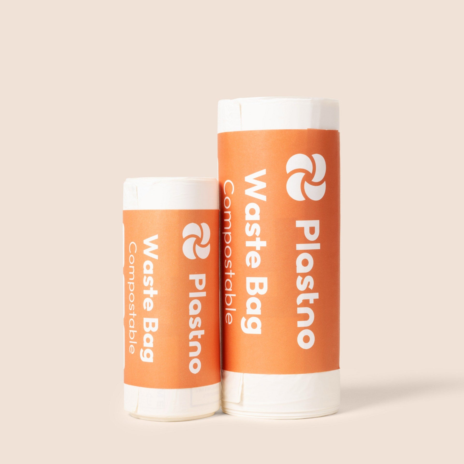 Short and tall rolls of Plastno compostable waste bags side by side in orange banded packaging on a beige background