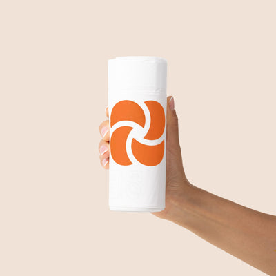 Hand holding a roll of 30 Plastno 4 gallon compostable trash bags
