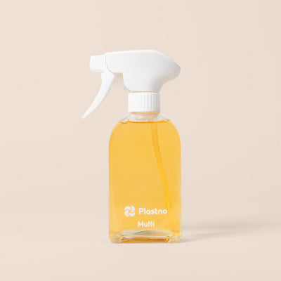 Plastno Multi cleaner glass spray bottle filled with cleaner on a beige background