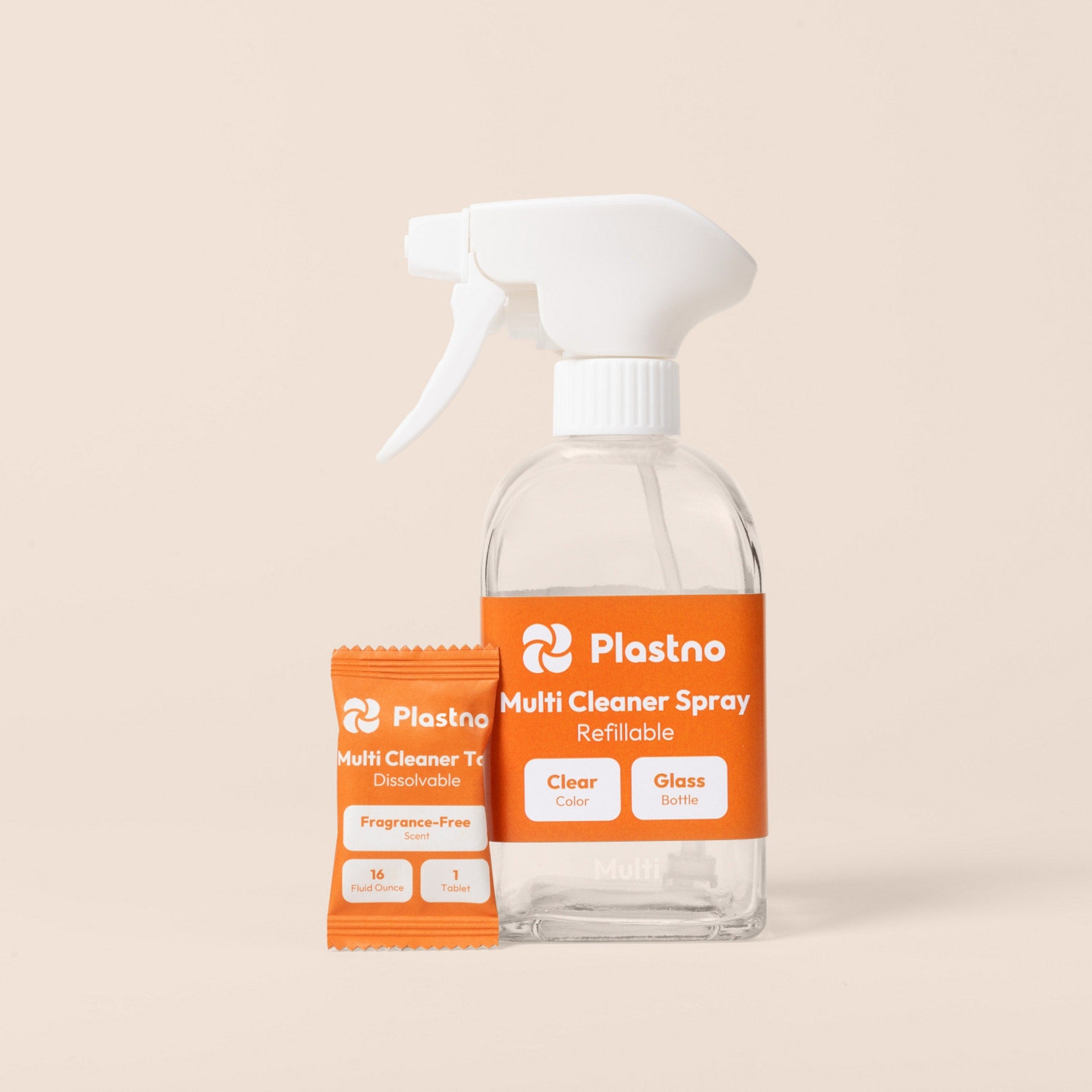 Plastno refillable Multi Cleaner Spray glass bottle next to a fragrance-free multi cleaner tablet packet on a beige background