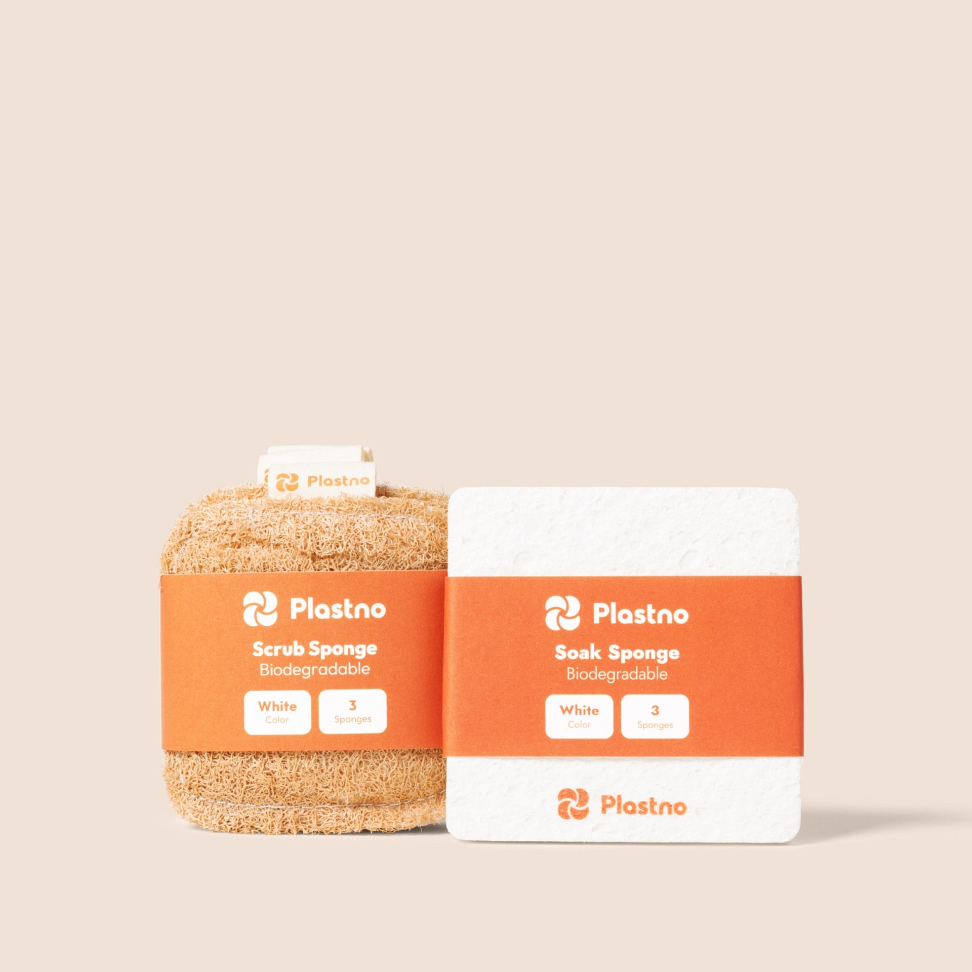 Plastno biodegradable Scrub Sponge and Soak Sponge 3-packs side by side in orange banded packaging on a beige background